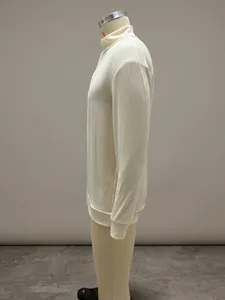 Side profile detail of a cream quarter-zip long-sleeve wool blend knit polo shirt
