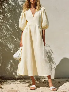 Elegant cream V-neck puff sleeve maxi dress featuring linen texture and A-line silhouette