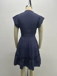 Back view of a navy blue polka dot A-line dress with ruffled sleeves