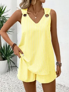 Detail of yellow striped V-neck tank top and shorts set with metal buckle accents.