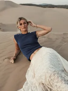 Close-up detail of a navy blue sleeveless ribbed knit top worn in a desert setting