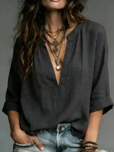 Close-up detail of women's dark grey linen-textured blouse with deep V-neck