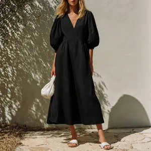 Elegant black V-neck midi dress with puff sleeves and A-line silhouette for summer vacation