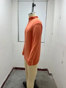 Side view of orange long-sleeve quarter-zip men's wool polo shirt on mannequin