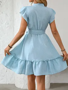 Back view of a light blue polka dot summer dress with ruffle sleeves and A-line hem