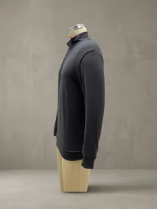 Detailed side view of a charcoal grey quarter-zip long sleeve pullover on a torso mannequin