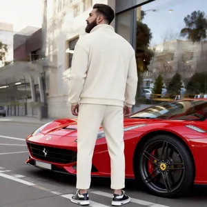 Rear view of men's cream corduroy stand-collar tracksuit set shown in urban street scene