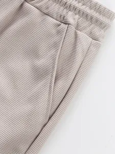 Macro view showing the waffle knit texture and pocket detail of these casual pants