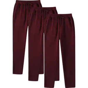 Detail showing three pairs of burgundy wine red fleece-lined men's joggers for autumn