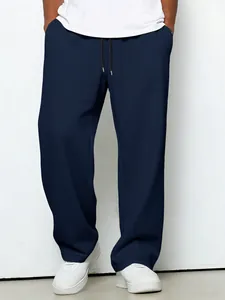 Detailed view showing the navy blue waffle knit texture of loose casual drawstring pants