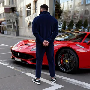 Men's navy blue corduroy half-zip tracksuit set shown from behind in street setting.