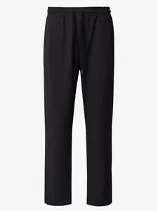 Close-up of black waffle-knit pants with adjustable drawstring waist and straight leg.