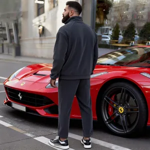 Detailed view of grey corduroy tracksuit for men standing next to a red sports car