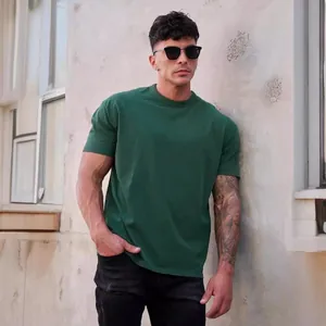 Athletic fit dark green crew neck T-shirt for men shown in a lifestyle outdoor setting