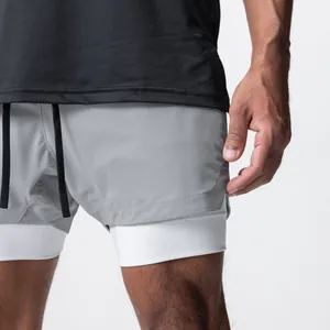 Nahaufnahme der zweilagigen schnelltrocknenden Sportshorts für Herren in Grau und Weiß.