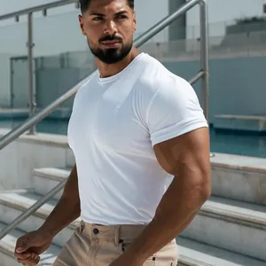 Close-up showing the athletic fit of a white cotton blend fitness T-shirt on a model
