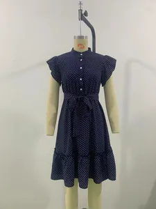 Vintage navy blue polka dot A-line dress with ruffle sleeves and button front.