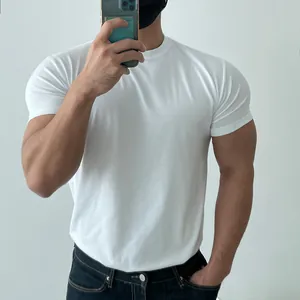 Close-up of a muscular man wearing a tight white crew neck athletic fitness t-shirt
