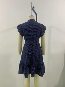 Back view of navy blue polka dot dress with ruffle hem on a tailor's mannequin