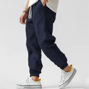 Detail of breathable navy blue men's linen jogger pants with elastic drawstring waist