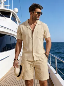 A male model wearing a casual beige linen shirt and shorts set on a yacht deck