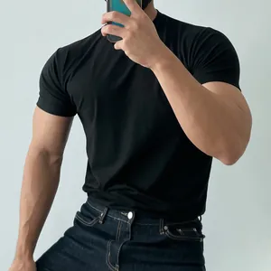 Detail of a black slim-fit men's athletic T-shirt showing muscle-enhancing fit.