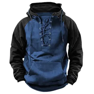 Macro detail of a two-tone blue and black hoodie with a stylish lace-up front neck.