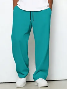 Close-up detail of teal waffle knit straight-leg casual pants with drawstring waist
