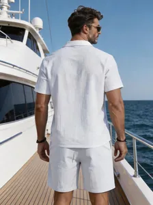 Detailed back view of men's white linen short sleeve shirt and shorts set on a luxury yacht