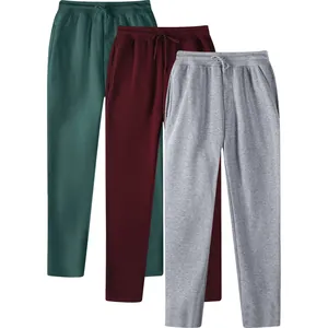 Detailed macro view of men's fleece-lined sports joggers in green, burgundy, and grey colors