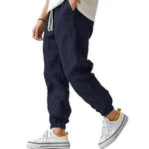 Men's navy blue cotton linen joggers with elastic drawstring waist and cuffed ankles.