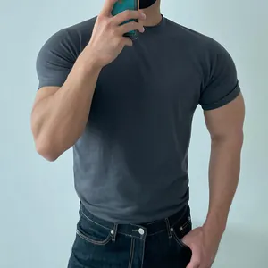 Detail shot of a men's athletic fit solid charcoal grey T-shirt for gym workout sessions