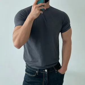 Detailed mirror selfie of a grey slim fit training t-shirt showing the muscle fit