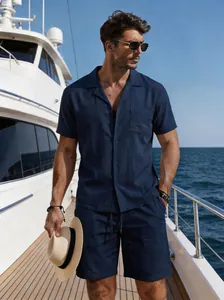 Model wearing navy blue linen summer set standing on yacht deck under clear blue sky