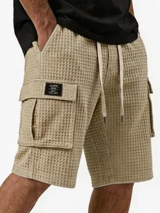 Nahaufnahme der khakifarbenen Waffelstrick-Cargo-Shorts für Herren mit Taschen-Patch
