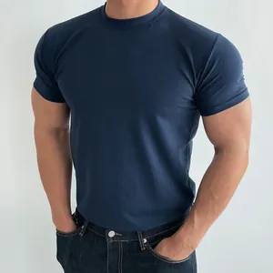 Macro view of muscular fit navy blue short sleeve training t-shirt for active men