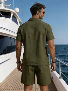 Rear view of a men's olive green linen short-sleeved shirt and shorts set on a yacht.
