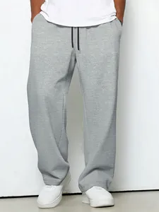 Detail shot of grey waffle knit casual pants with drawstring and straight leg