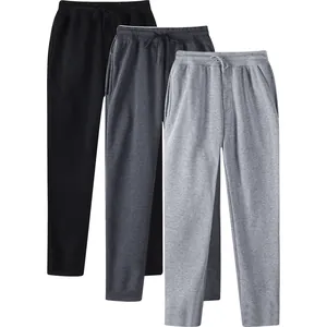 Detailed view of three pairs of straight-leg fleece sweatpants showing texture and color variety.