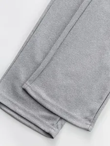 Detailed macro view of grey waffle textured fabric and hem of casual sport pants.