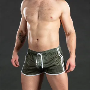 Men's breathable army green mesh quick-dry gym shorts shown on a muscular fitness model.