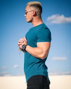 Side view detail of teal cotton athletic t-shirt with curved hem on muscular male model.