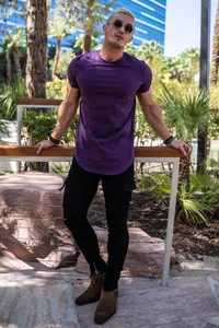 Outdoor lifestyle view of men's purple slim fit curved hem cotton t-shirt outfit