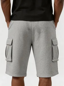 Detailansicht der grauen Cargo-Shorts aus Waffelstruktur mit Seitentaschen am Modell