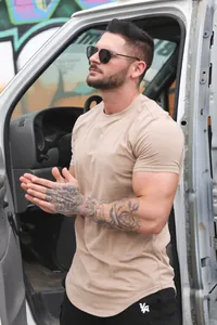 Detailed view of a beige men's cotton t-shirt paired with shorts for casual summer sports