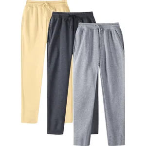 Close-up of three pairs of men's fleece-lined sweatpants in beige, charcoal, and grey