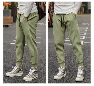 Detail of men's sage green tapered joggers with drawstring waist and ribbed cuffs
