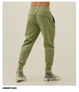 Back view of men's olive green athletic joggers with tapered cuffs and slim fit