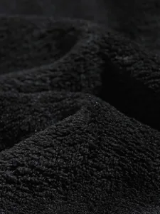 Detailed macro close-up of soft black coral fleece fabric texture for men's winter hoodie