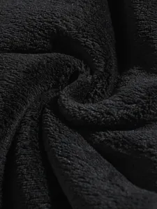 Macro detail of black coral fleece fabric showing its soft and dense plush texture